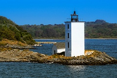 Dutch Island Lighthouse Tower Over Rocky Shoreline
